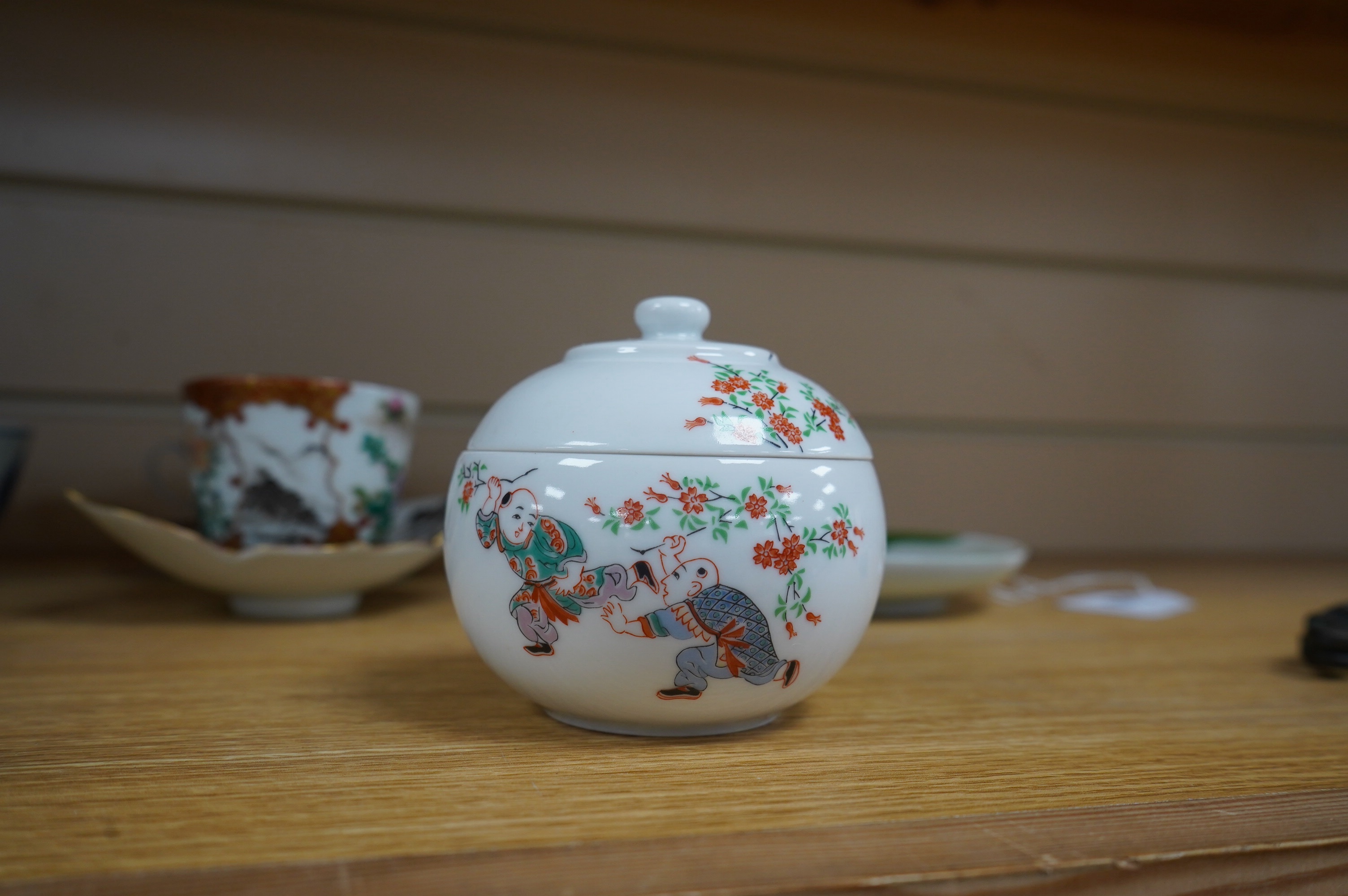 A group of Chinese and Japanese ceramics to include Yixing teapots, porcelain cups and saucers, a blue and white vase and a tiger talisman. Condition - mostly good